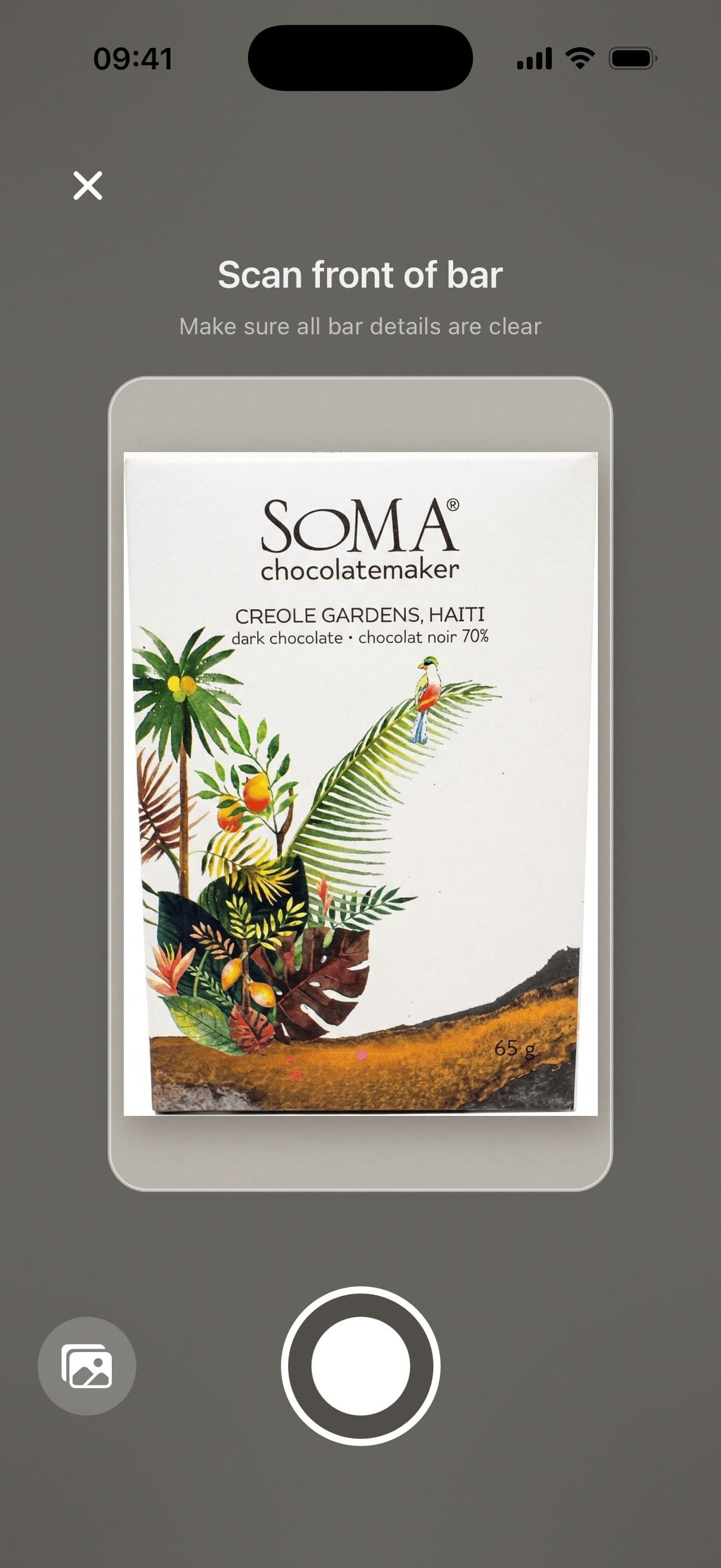 The Chof scanner with a SOMA Creole Gardens bar lined up in the scan frame, above the capture button
